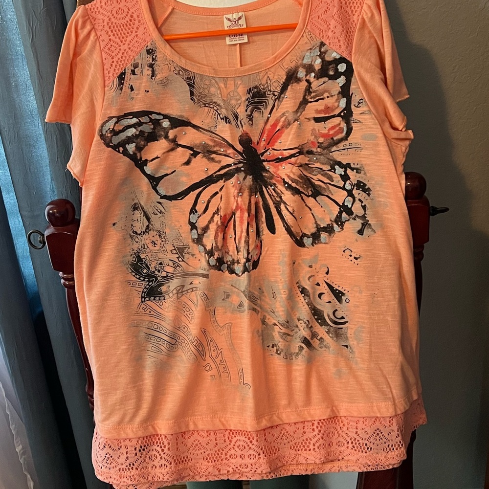 Women top size large orange color with butterfly on front